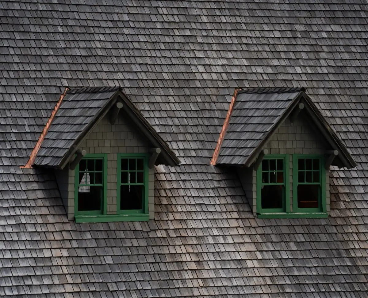 Dormers on a shingle roof in Sunrise, FL, where step flashing and kickout flashing carry water past the walls